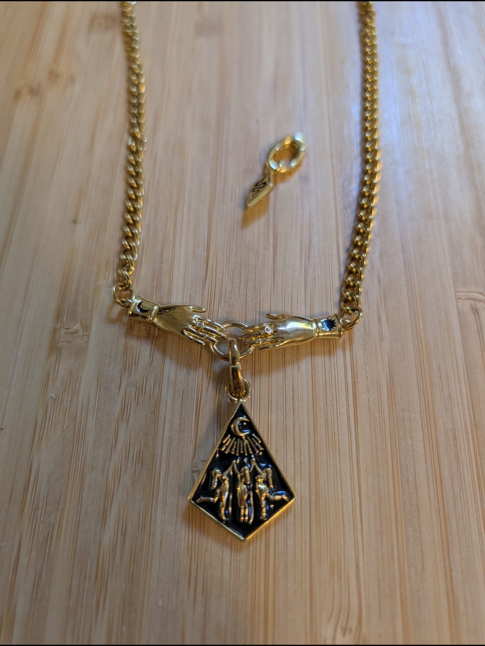 Gold and Black Hand-Link Pendant Necklace - Elegant Symbolic Charm